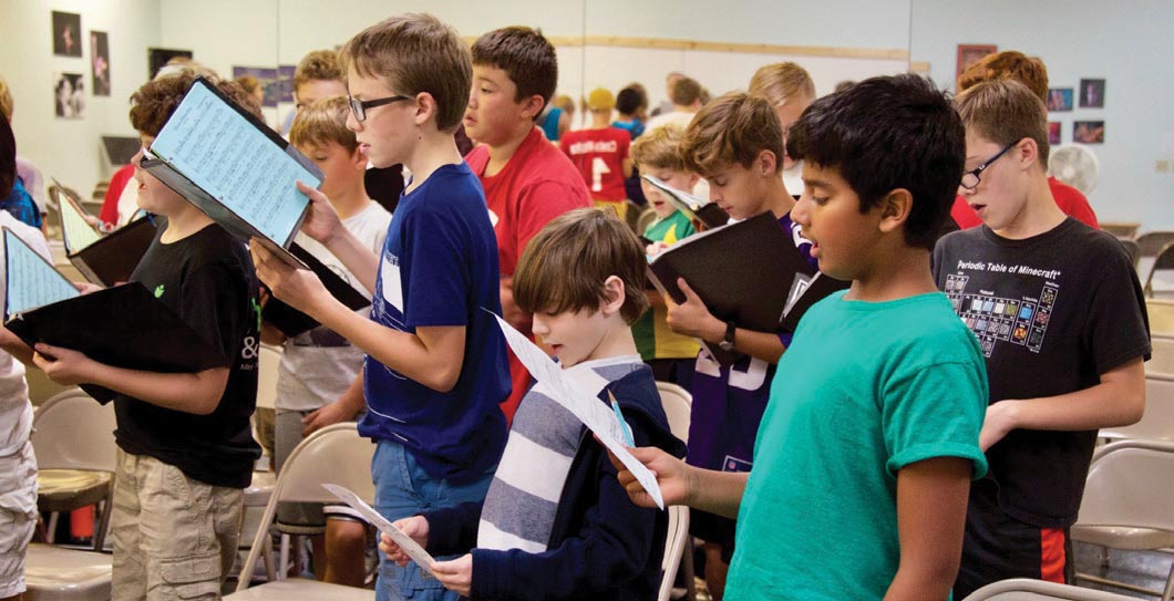 elementary school students singing in chorus class
