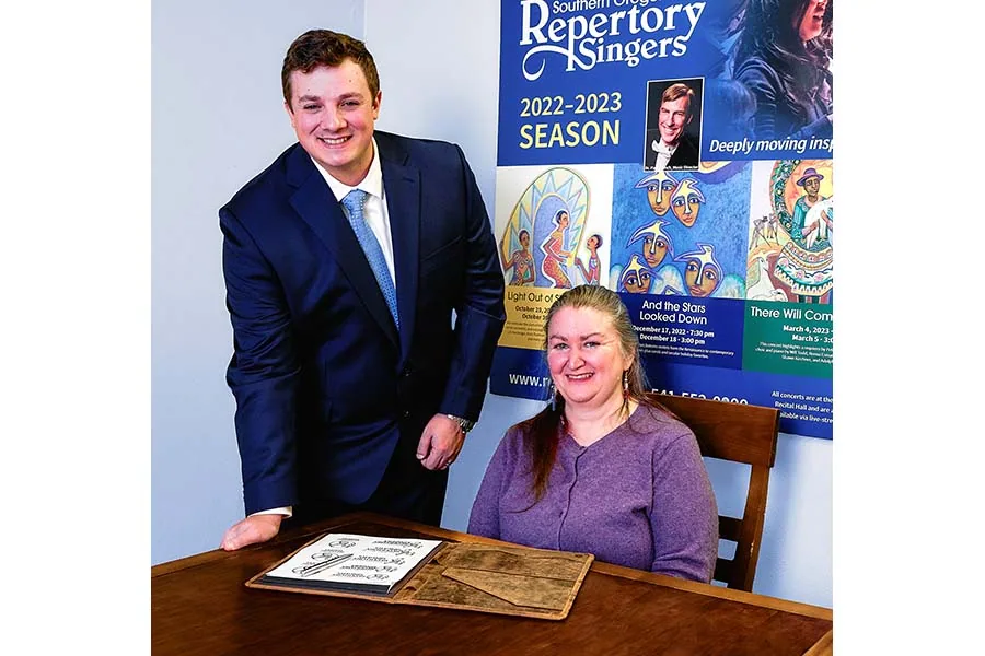 Rebecca Goldman., the new interim executive director of Southern Oregon Repertory Singers, goes over spring concert details with board member Erik Wiggins