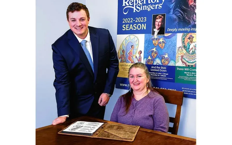 Rebecca Goldman., the new interim executive director of Southern Oregon Repertory Singers, goes over spring concert details with board member Erik Wiggins