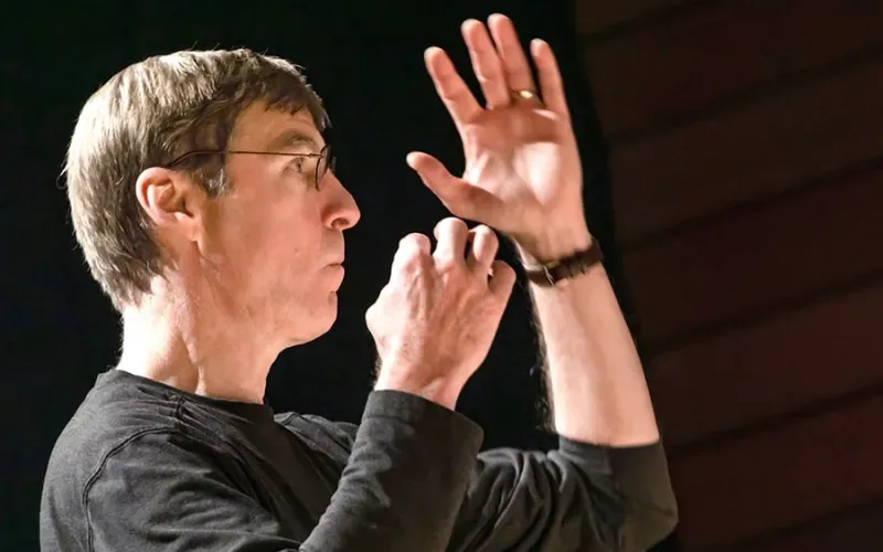 Music Director Paul French conducting during rehearsal
