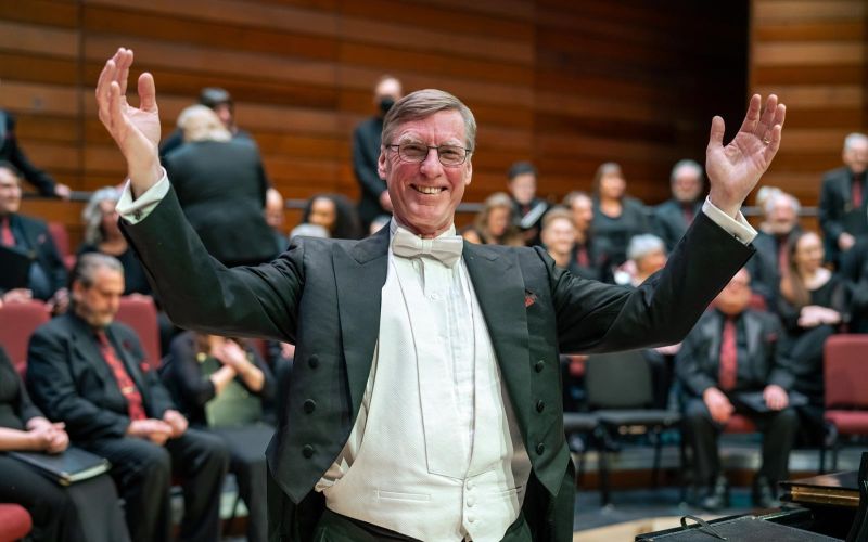 Music Director Paul French candid shot on stage during concert dress rehearsal break
